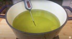 Pot of oil with a thermometer showing 324°F, ready for deep frying.